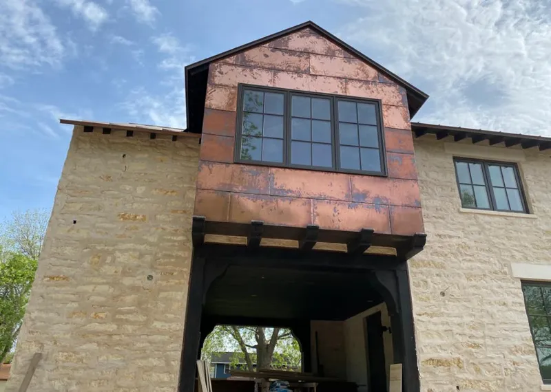 Copper metal panel facade on a stone building for Skylight Installation in Idylwood