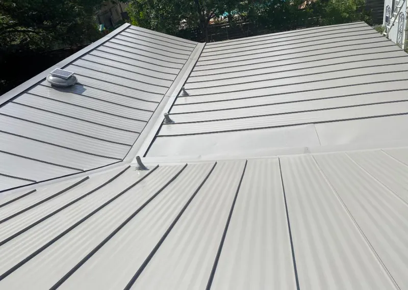 Solar attic fan installed on a metal roof for Roof Ventilation in Idylwood